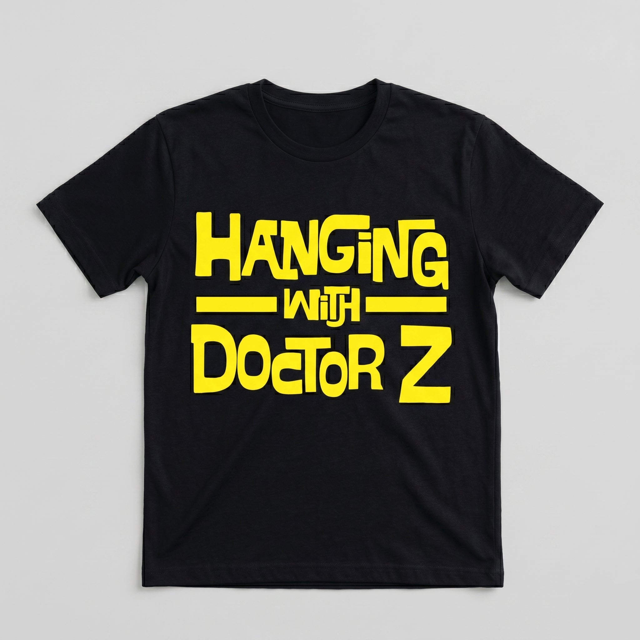 Black t-shirt with yellow text 'Hanging with Doctor Z' on a light gray background